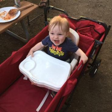 baby sitting in portable chair and wagon