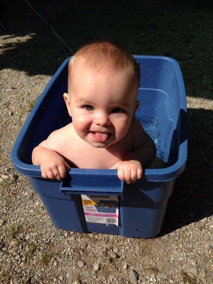 baby in rubbermaid container for outdoor bath