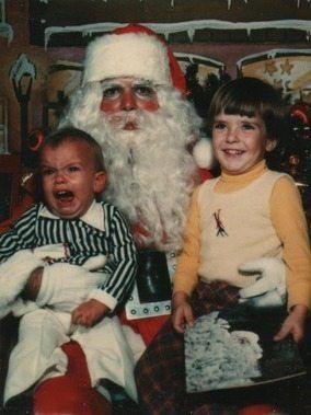 two kids (one freaking out) in a vintage christmas picture