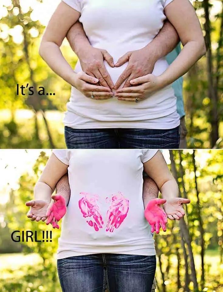 couple's hands on pregnant belly showing pink baby gender reveal