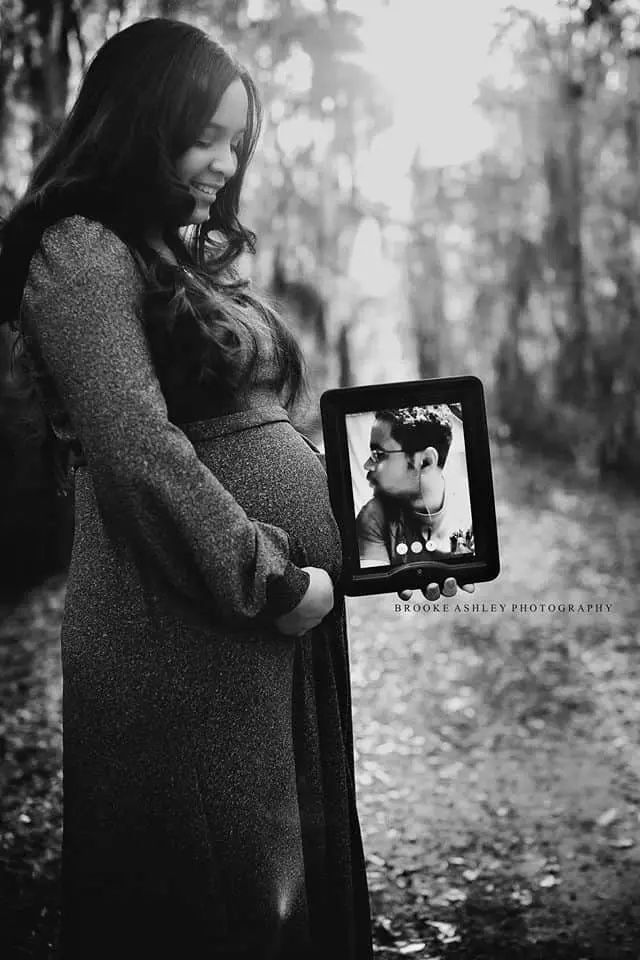black and white photo of expecting mom holding photo of daddy's portrait