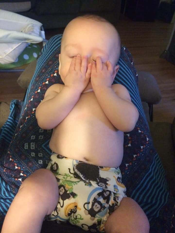 sleepy baby wearing cloth diaper