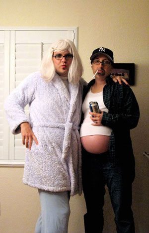 Husband and pregnant wife dressed as opposite sexes.