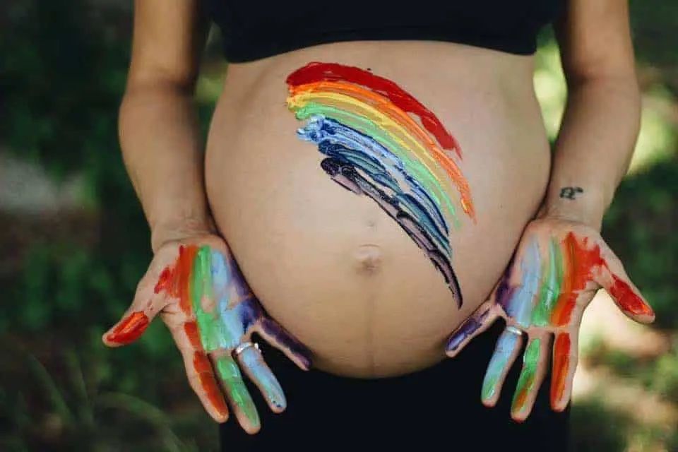 pregnant body with rainbow paint