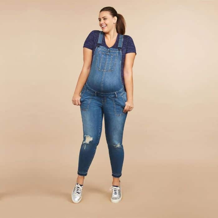 pregnant woman in plus sized denim overalls