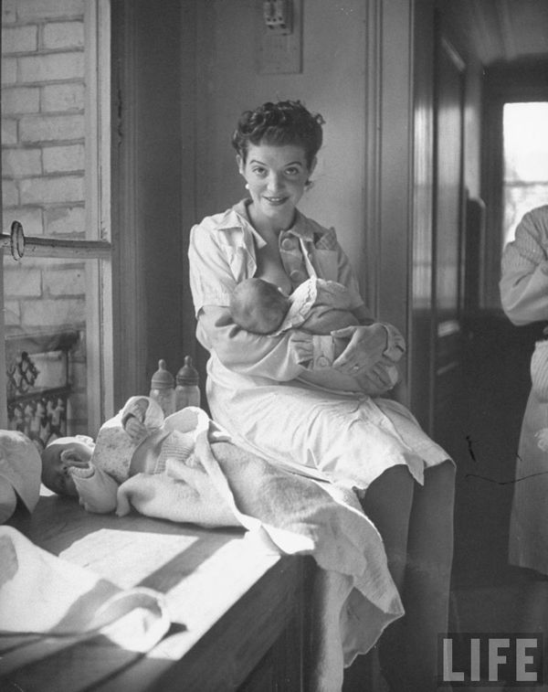 Black and white photograph of mother breastfeeding baby