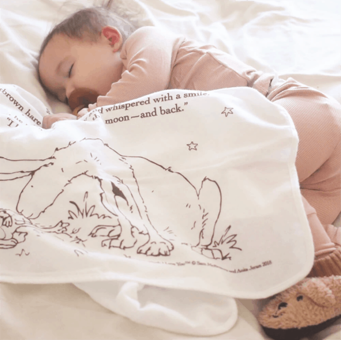 baby sleeping with storybook blanket