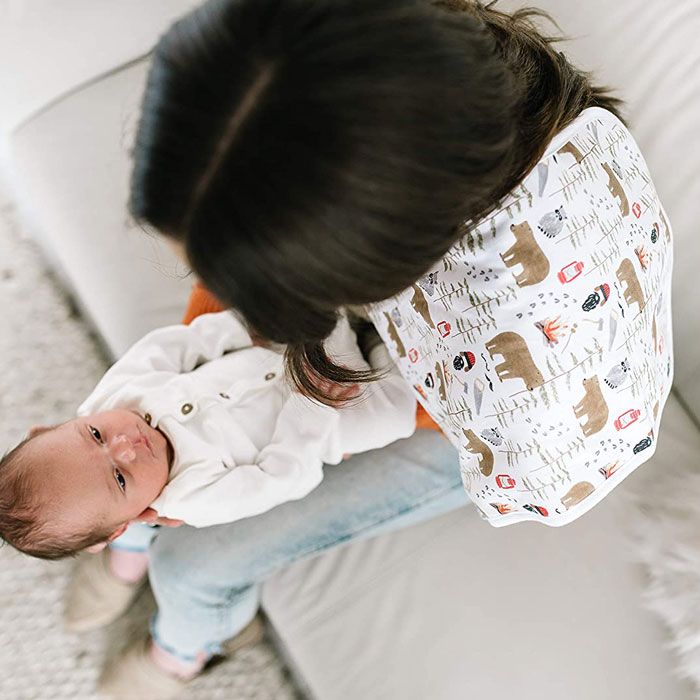 mom holding newborn with “Lumberjack” burp cloth by Copper Pearl