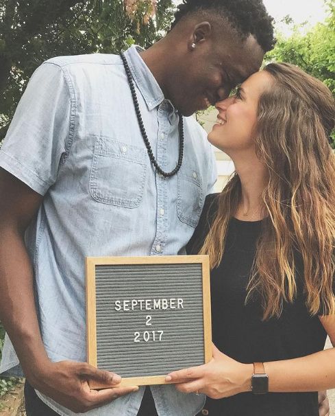 couple letterboard pregnancy announcement