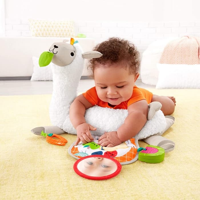 baby laying on llama tummy time pillow