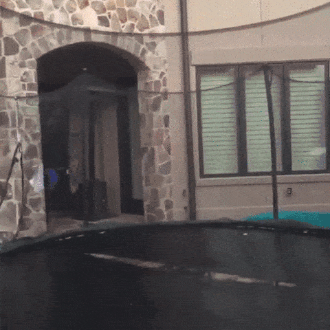 man falling through trampoline in reverse