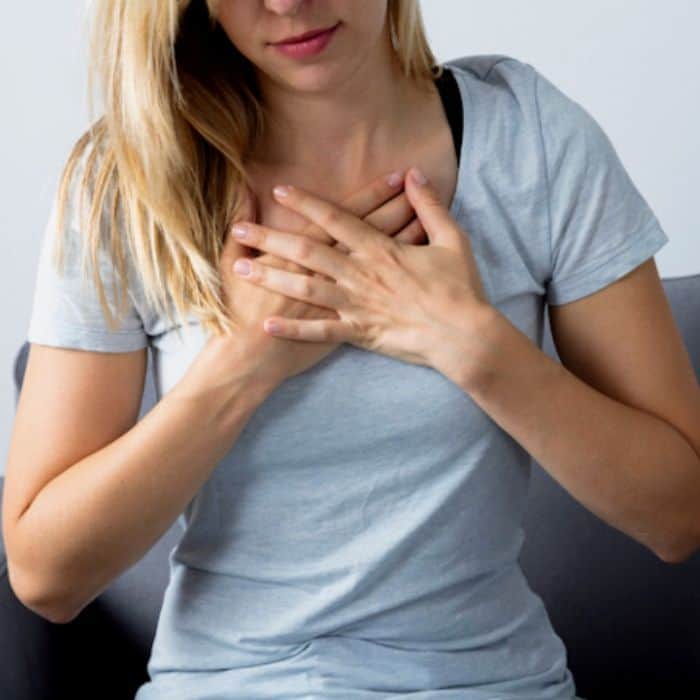 woman uncomfortable from heartburn