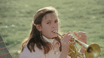 girl playing trumpet giving the finger