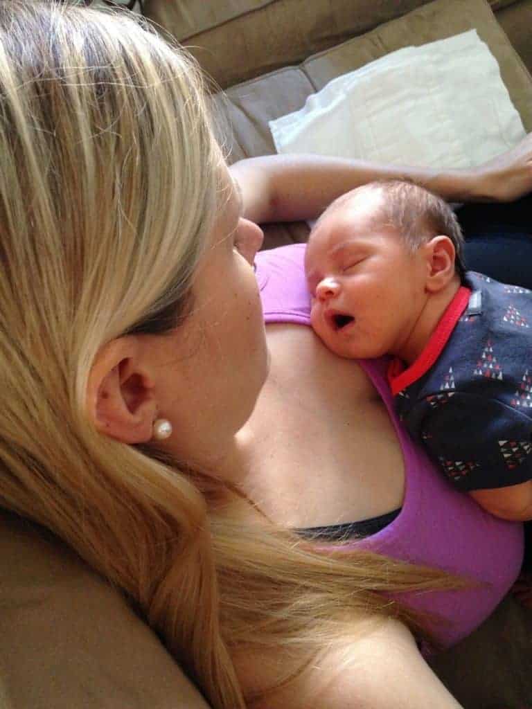 mom holding sleeping newborn on her chest