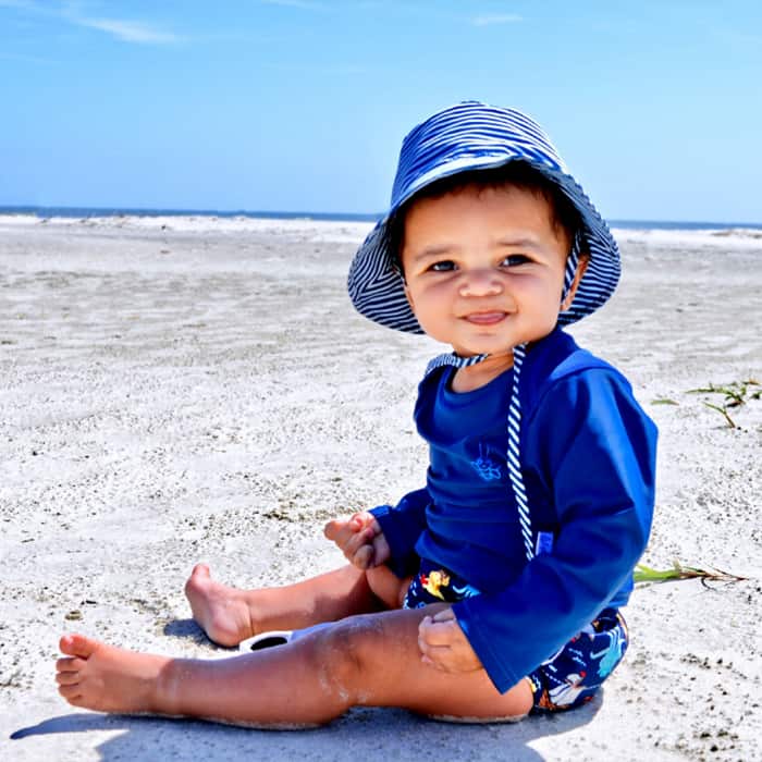 Gift ideas for newborn: baby on the beach wearing an iPlay Swim Diaper