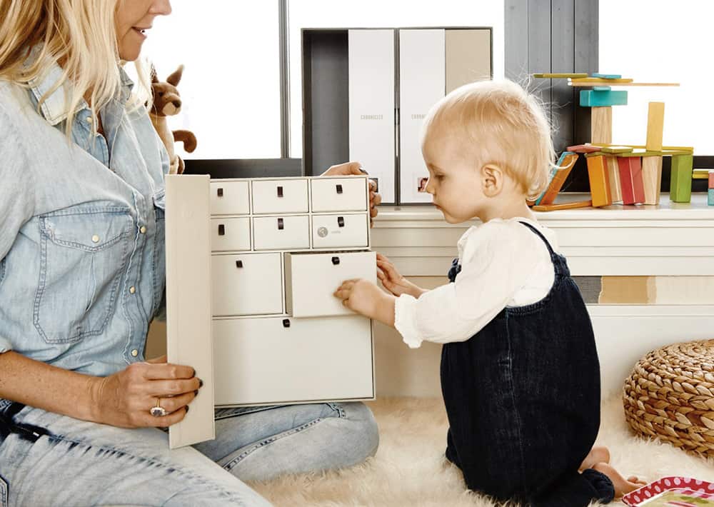 Mom and baby with a storage box used to save baby memories