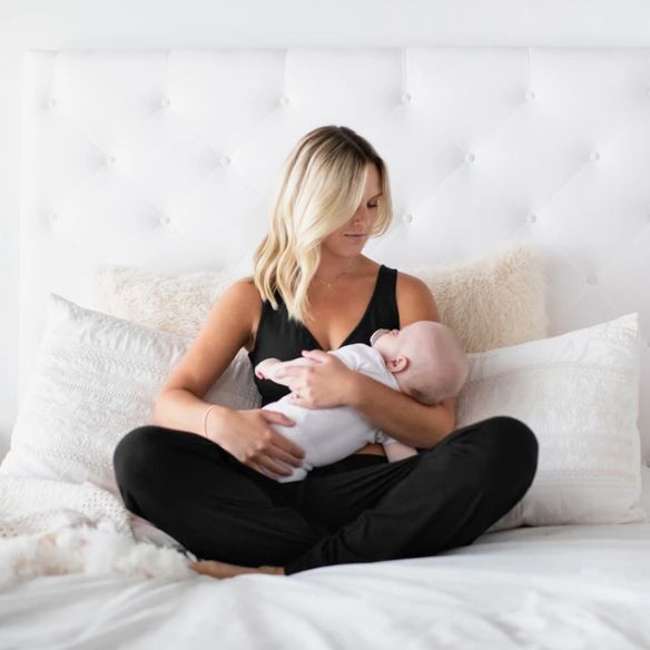 woman in nursing pajamas holding her baby