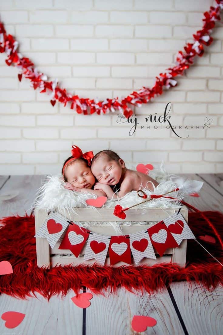 Twins sleeping in white box decorated with hearts Baby's First Valentine's Day Photo shoot