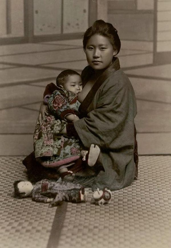 Black and white photograph of mother breastfeeding baby