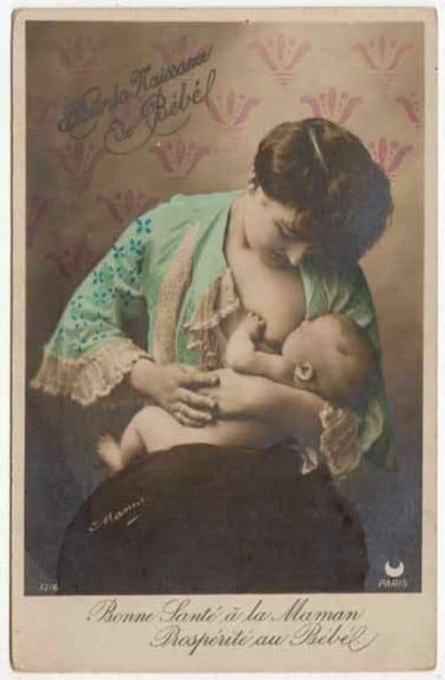 Color retouched vintage photograph of woman staring down at baby while it nurses wearing green robe with lace cuffs