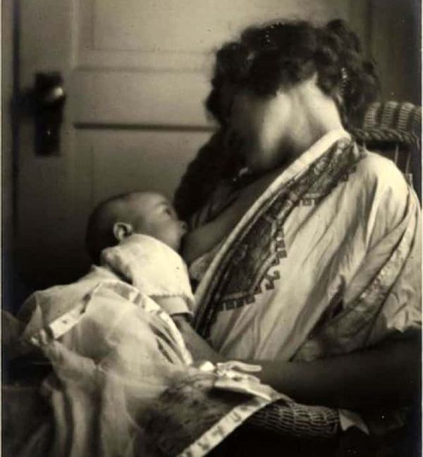 Black and white photograph of mother breastfeeding baby