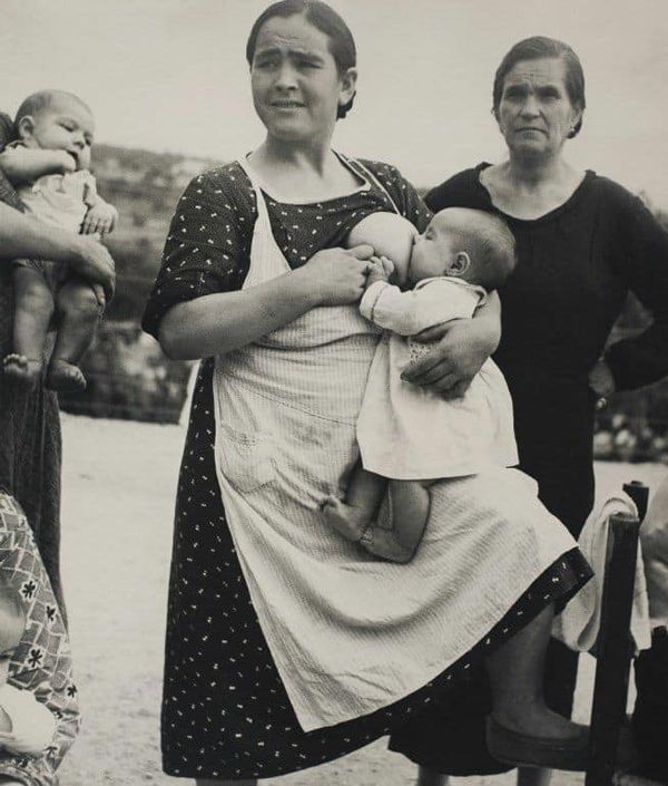 Black and white photograph of mother breastfeeding baby