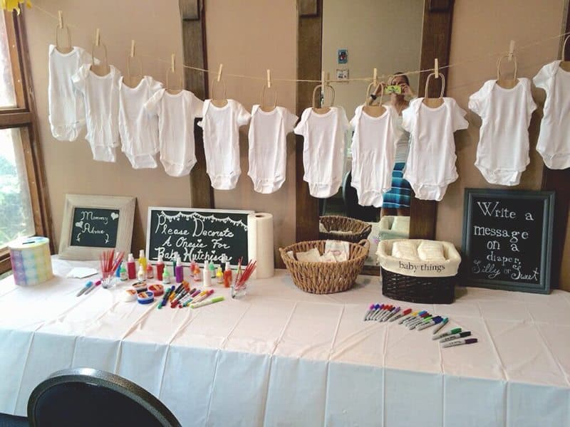 onesies along a clothes line for baby shower game
