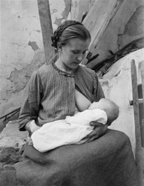 Black and white photograph of mother breastfeeding baby