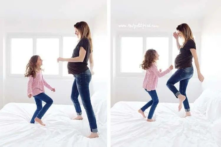 pregnant mom and child jumping on bed 