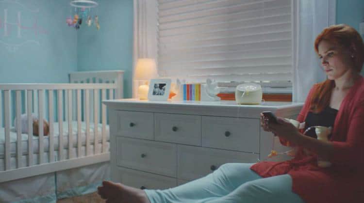 mom pumping breastmilk at night looking at phone
