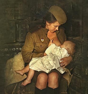 Black and white photograph of mother breastfeeding baby