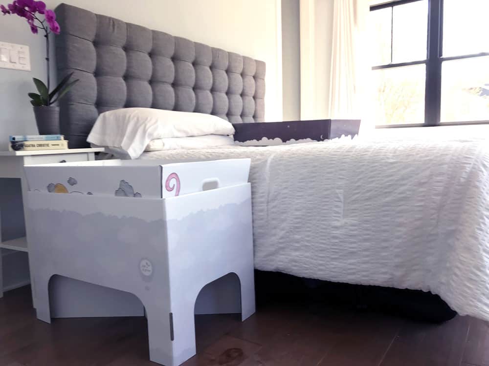 smitten baby box with stand next to bed follows safe sleep guidelines