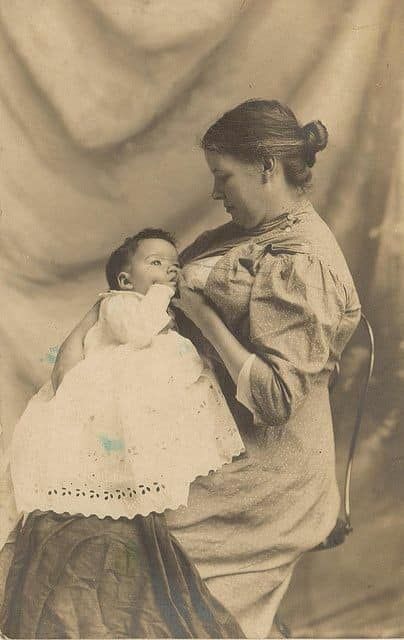 Black and white photograph of mother breastfeeding baby