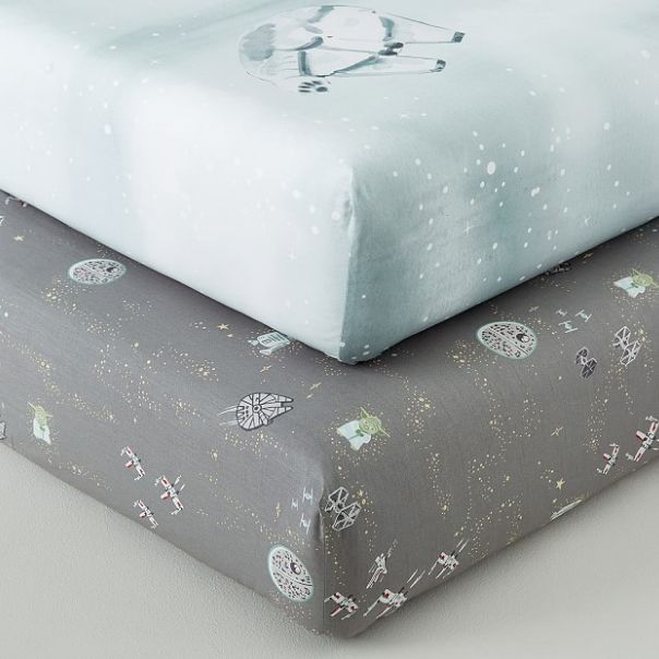 Pottery Barn Star Wars crib sheets featuring the Death Star, TIE fighters, X-Wings, Yoda, and the Millennium Falcon