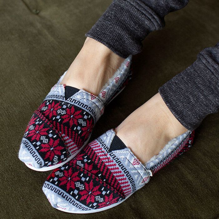 toms slippers on a pregnant person's feet