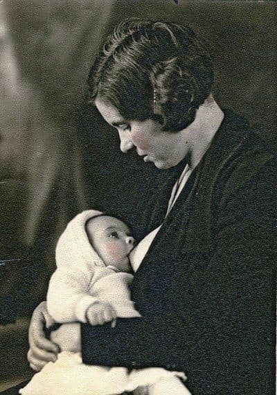 Black and white photograph of mother breastfeeding baby