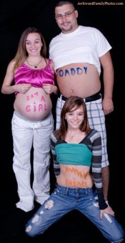 Three people pose for photo with shirts pulled above their bellies. Pregnant woman's belly reads, "it's a girl", male belly reads, "daddy", third female's belly reads, "Aunty Yayah!!"