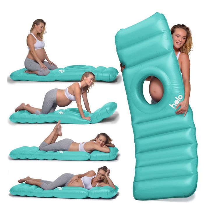 pregnant woman lying on inflatable maternity pillow