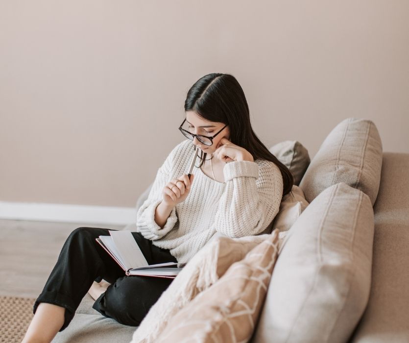 woman checking off tasks on here baby prep checklist