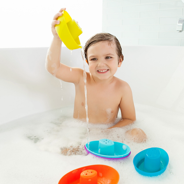 child in bath pouring Boon Stacking Boats