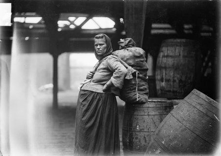 Pregnant woman with large sack on her back during the 1904 Stockyards Strike