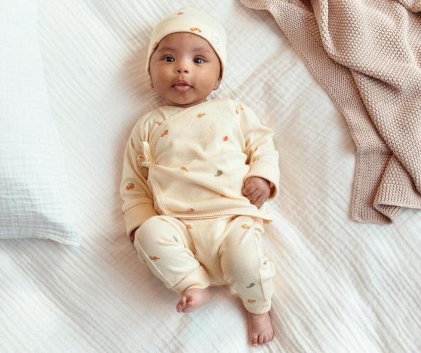 baby wearing cream colored set of clothes from H&M
