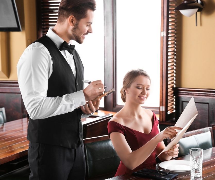 woman pointing to lanugo on the menu for a waiter