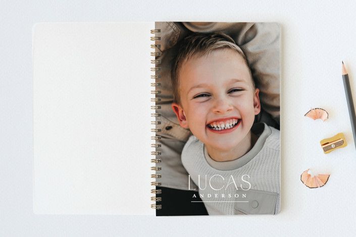 little boy on the cover of a personalized notebook