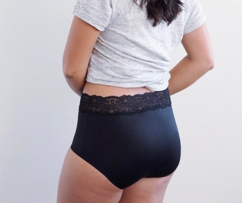 woman wearing black postpartum briefs with lace trim