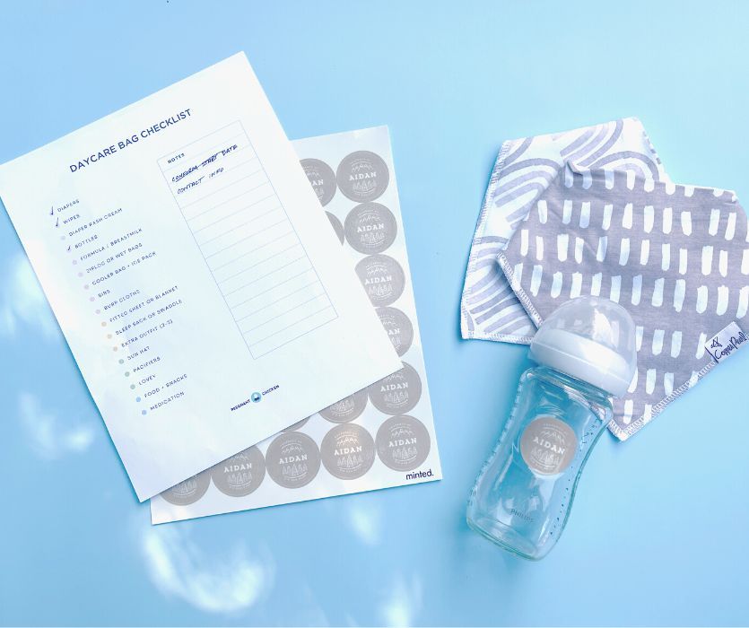 daycare bag checklist with labels, baby bottle and bibs