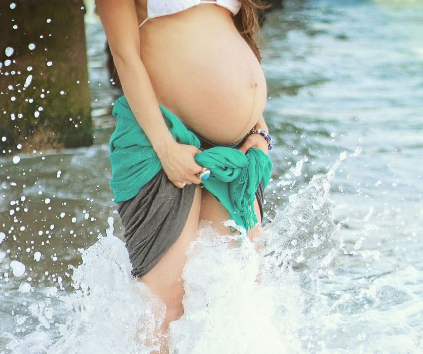 pregnant woman in the ocean surf
