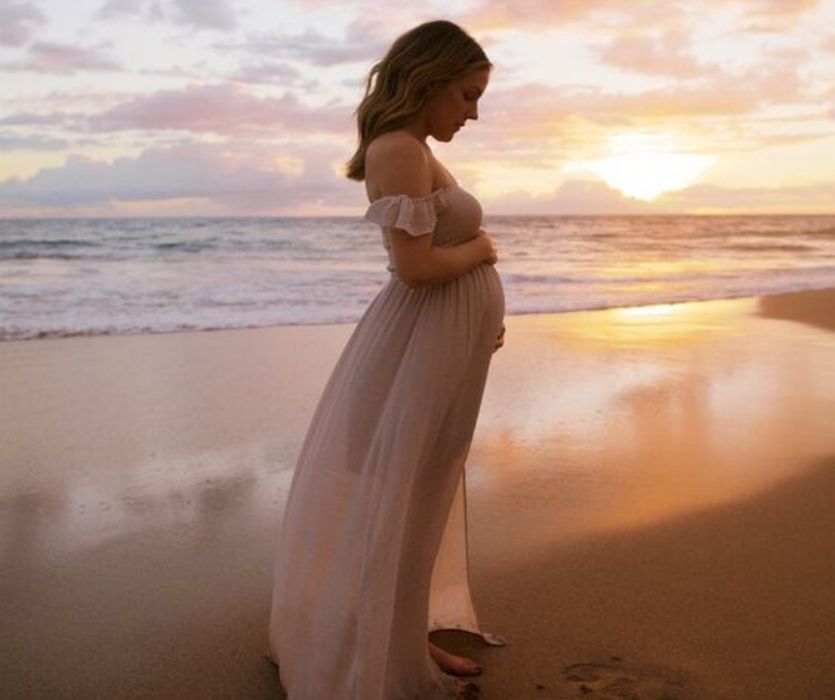 sunset photo of pregnant mom in flowy dress