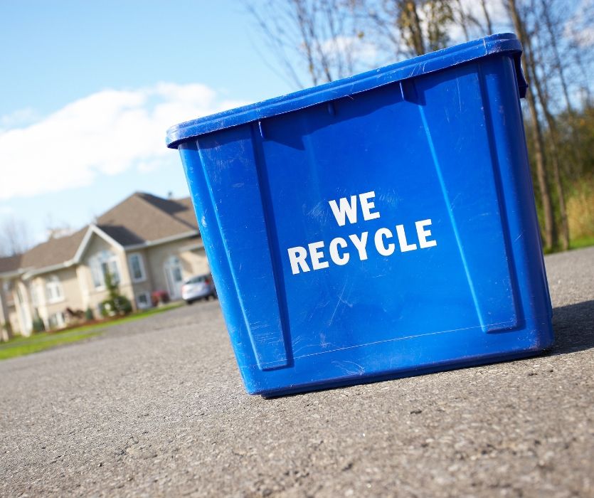 blue recycle bin on the street