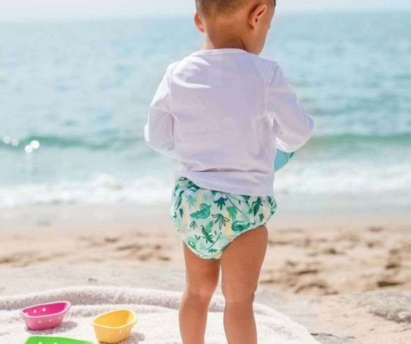baby wearing swim diaper at the beach